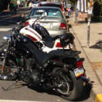 Motorcycle parking on busy street